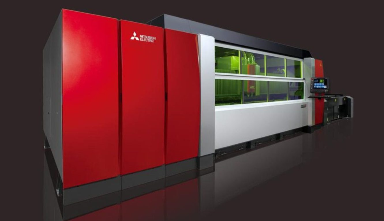 Large red industrial machine with a glass viewing section on a dark studio background.